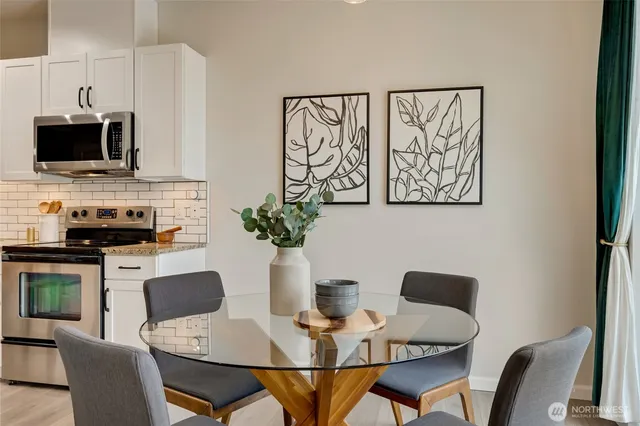 a dining room with furniture and wooden floor