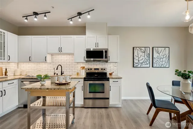 a kitchen with a stove a sink and a refrigerator