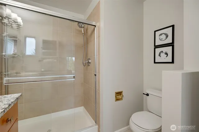 a bathroom with a toilet and a shower
