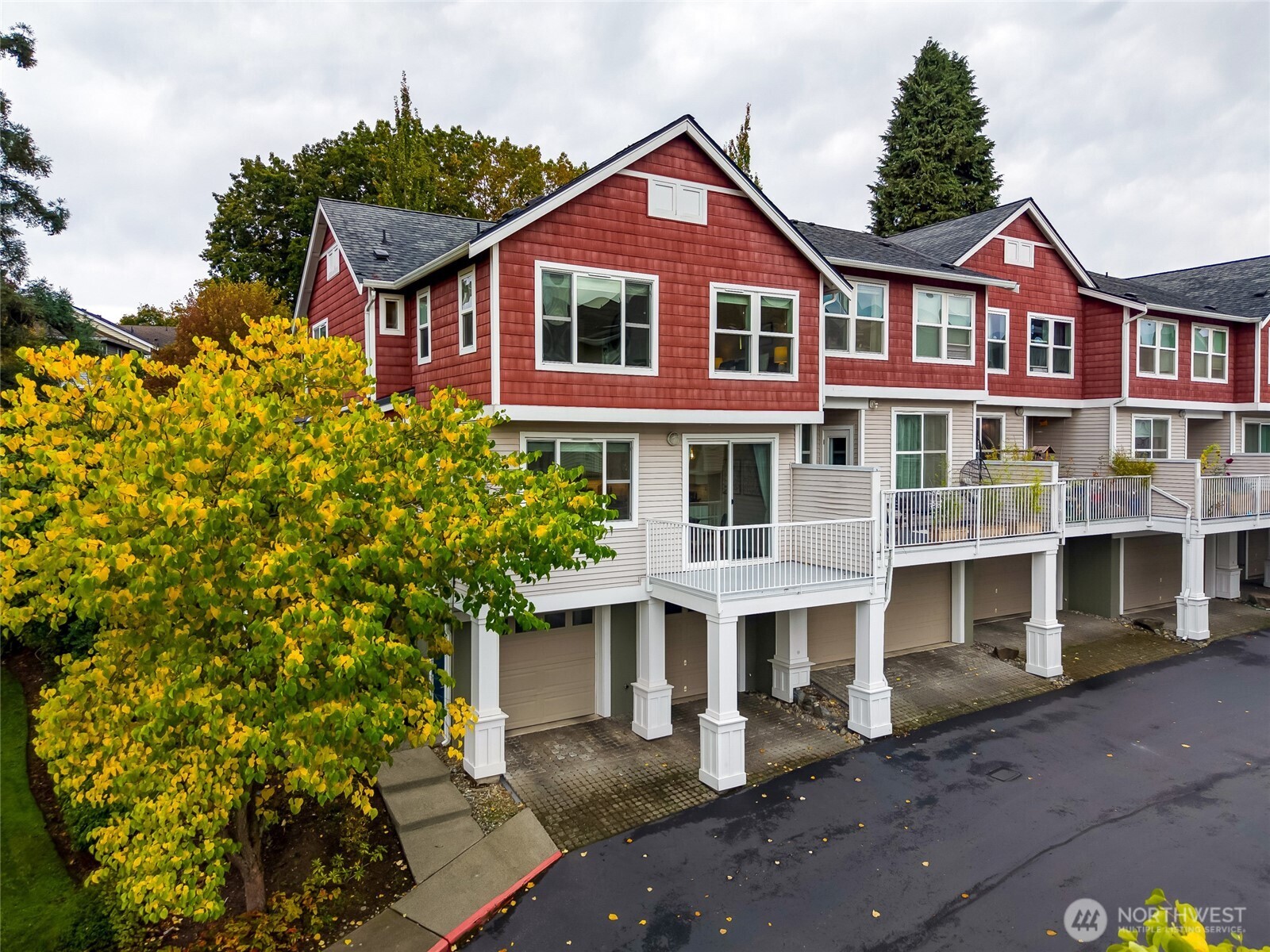 2800 Southwest Raymond Street, Unit 207 Seattle, WA 98126 - Photo 31 of 38 a front view of a residential apartment building with a yard