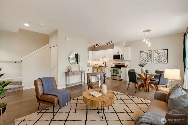 a living room with furniture and kitchen view