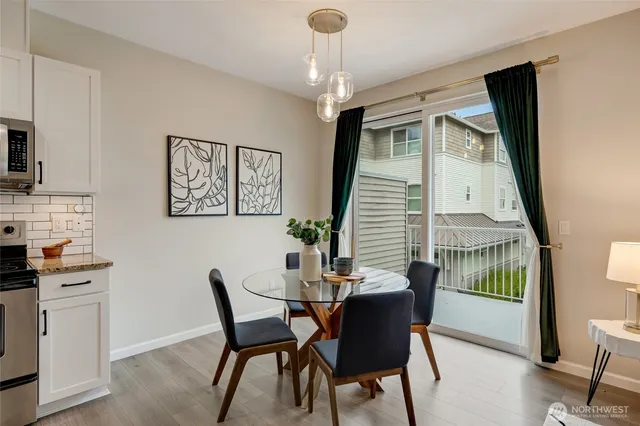 a dining room with furniture a chandelier and wooden floor