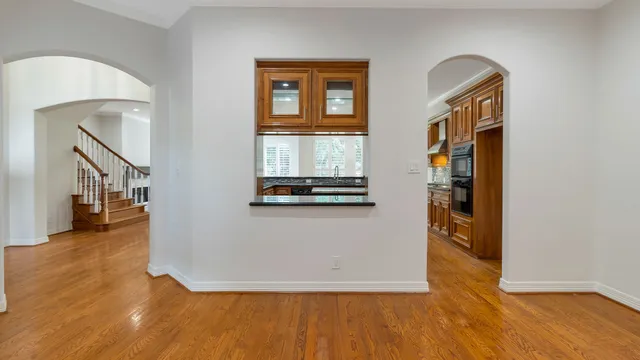 a view of a livingroom with wooden floor and furniture