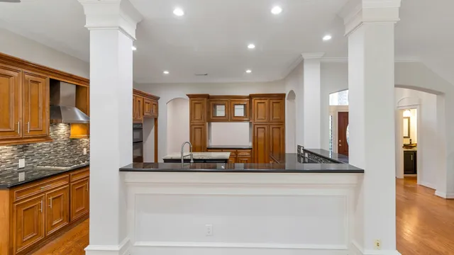 a large bathroom with a granite countertop sink and a large mirror