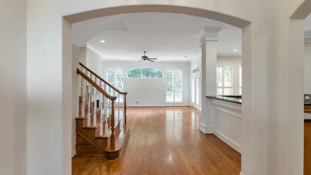 a view of entryway and hall with wooden floor