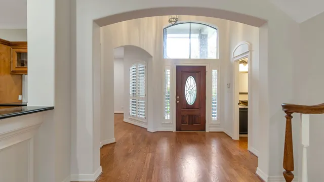 a view of an entryway with wooden floor