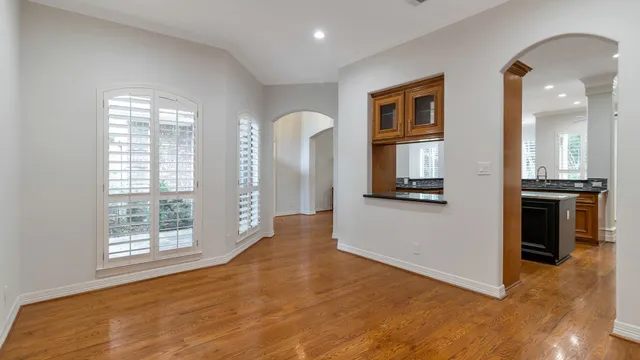 a view of a living room with windows and a kitchen