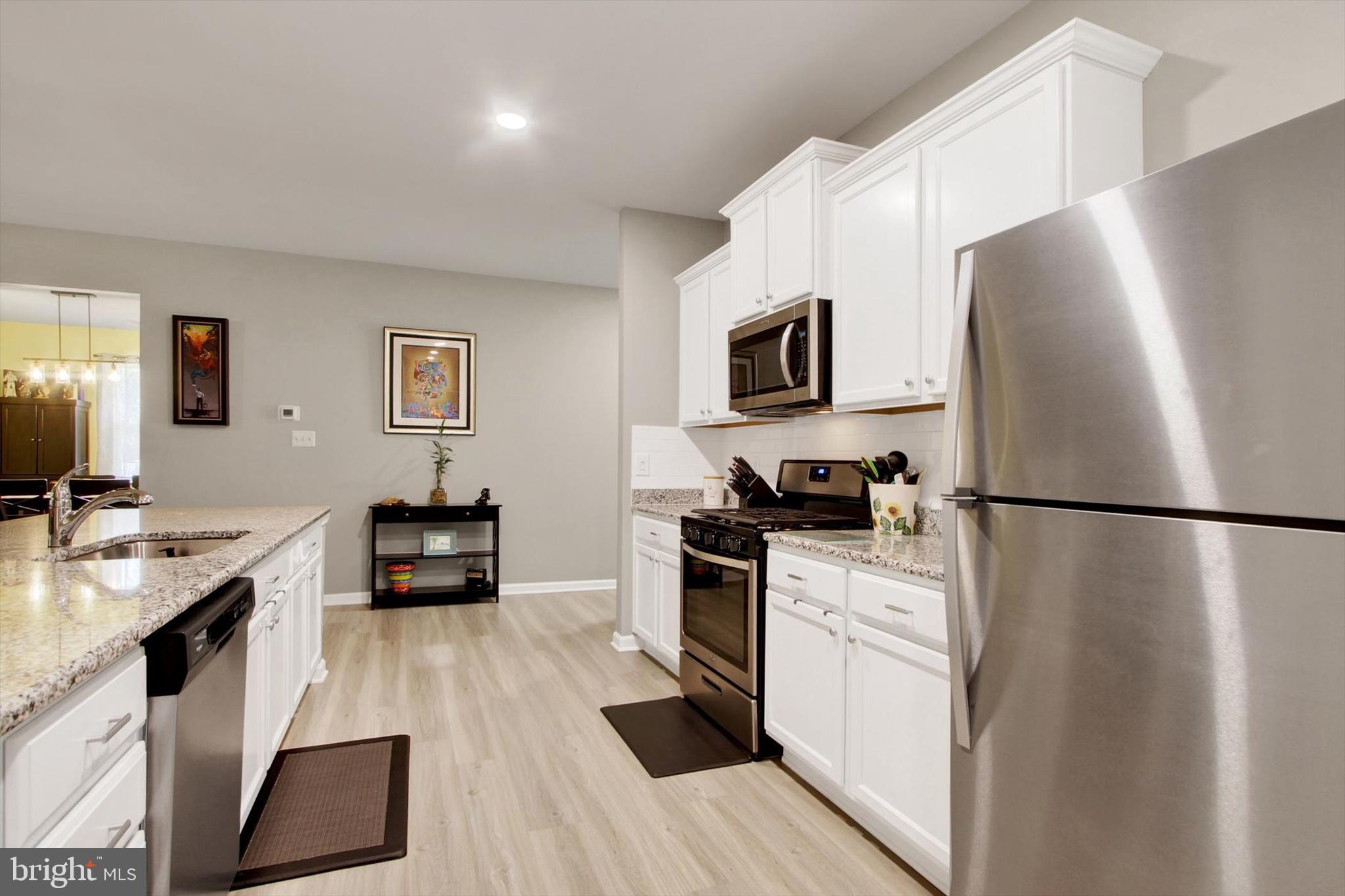 626 Ledger Drive Hanover, PA 17331 - Photo 7 of 37 a kitchen with white cabinets and stainless steel appliances