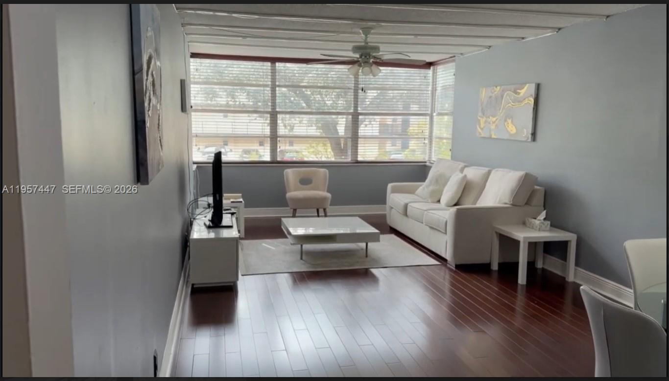 6600 Cypress Road, Unit 203 Plantation, FL 33317 - Photo 2 of 12 a living room with furniture and a large window