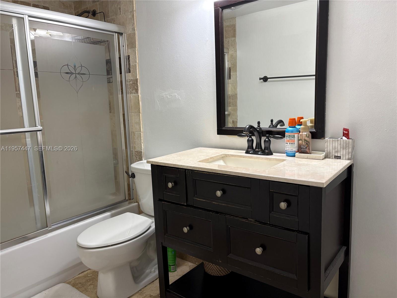 6600 Cypress Road, Unit 203 Plantation, FL 33317 - Photo 6 of 12 a bathroom with a sink vanity mirror and toilet