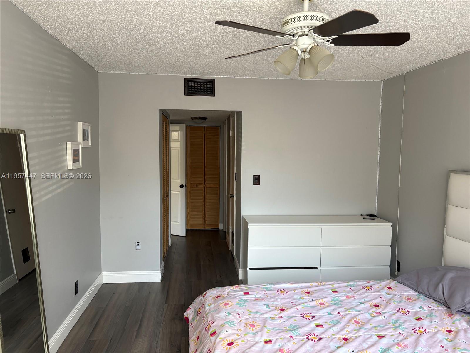 6600 Cypress Road, Unit 203 Plantation, FL 33317 - Photo 7 of 12 a bedroom with a bed and a dresser