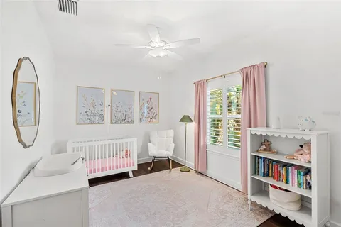 a bedroom with a bed and a book shelf