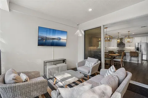 a living room with furniture and a view of kitchen