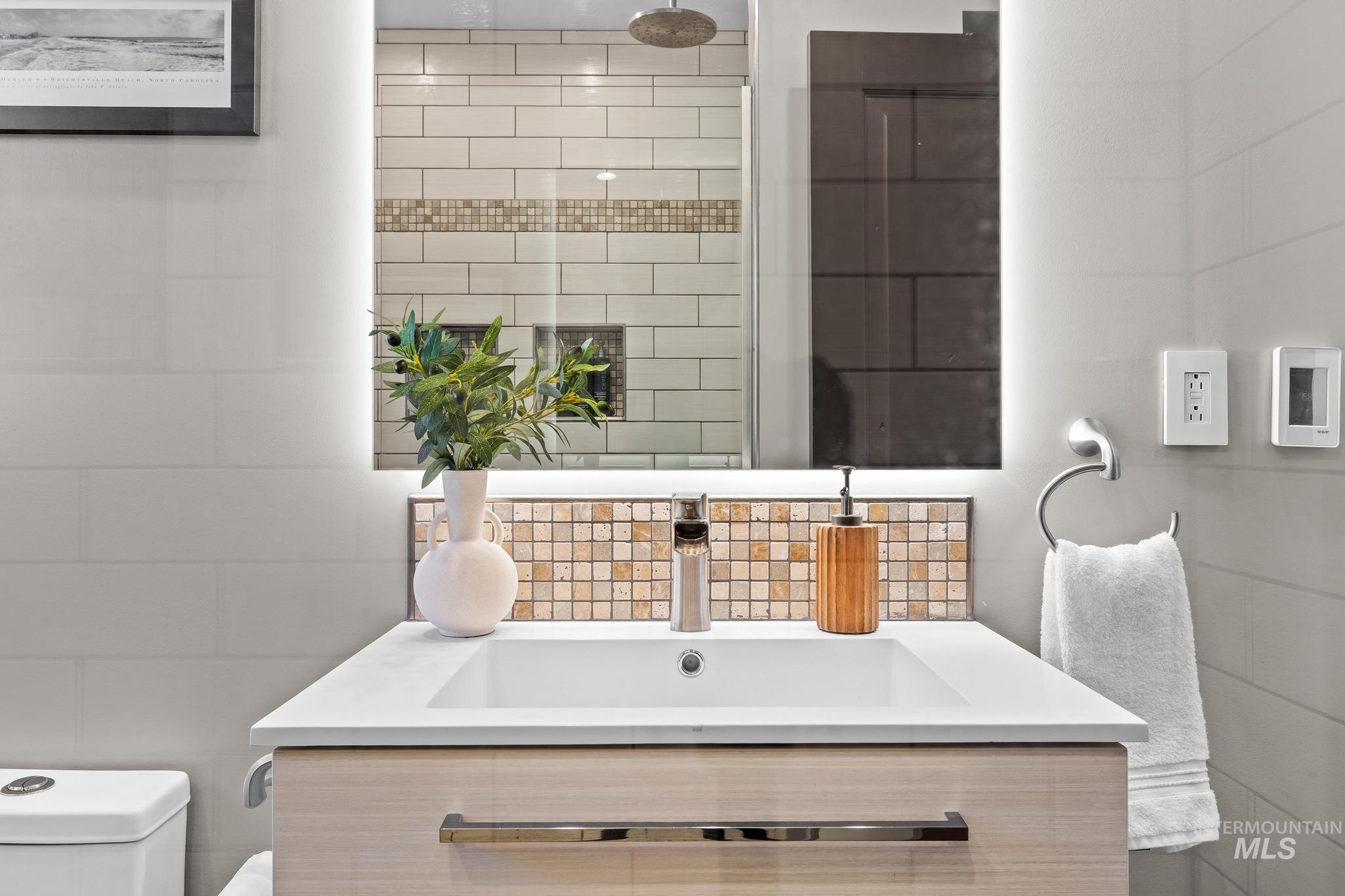 300 West Ofarrell Street Boise, ID 83702 - Photo 26 of 50 Bathroom with vanity, tile walls, and backsplash