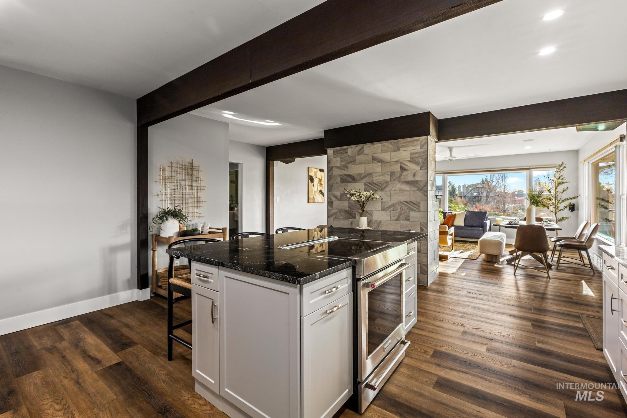 300 West Ofarrell Street Boise, ID 83702 - Photo 9 of 50 Kitchen featuring a breakfast bar, high end stainless steel range, dark stone counters, dark wood-style floors, and recessed lighting