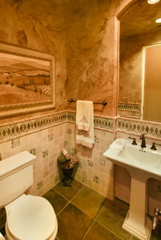 a bathroom with a sink mirror and toilet