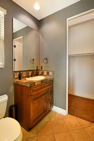 a bathroom with a sink toilet and mirror