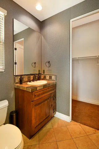 a bathroom with a sink toilet and mirror