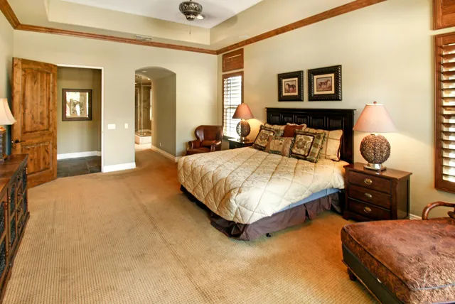 a bedroom with a bed and wall painting