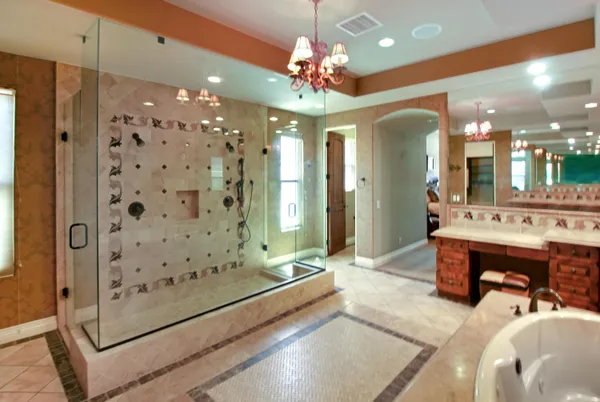 a spacious bathroom with a double vanity sink mirror and shower