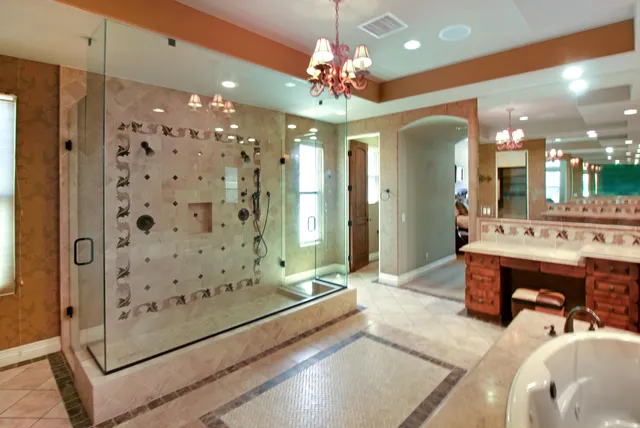 a spacious bathroom with a double vanity sink mirror and shower
