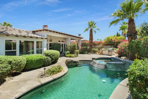 a bedroom with a bed and a table with projector