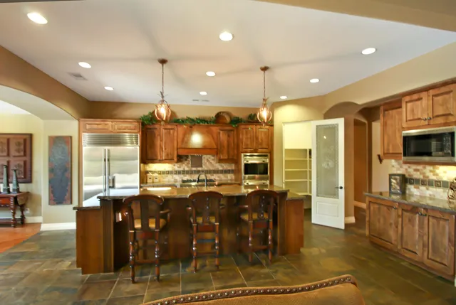 a large kitchen with a table and chairs