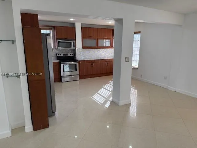 a kitchen with stainless steel appliances a refrigerator and a stove top oven