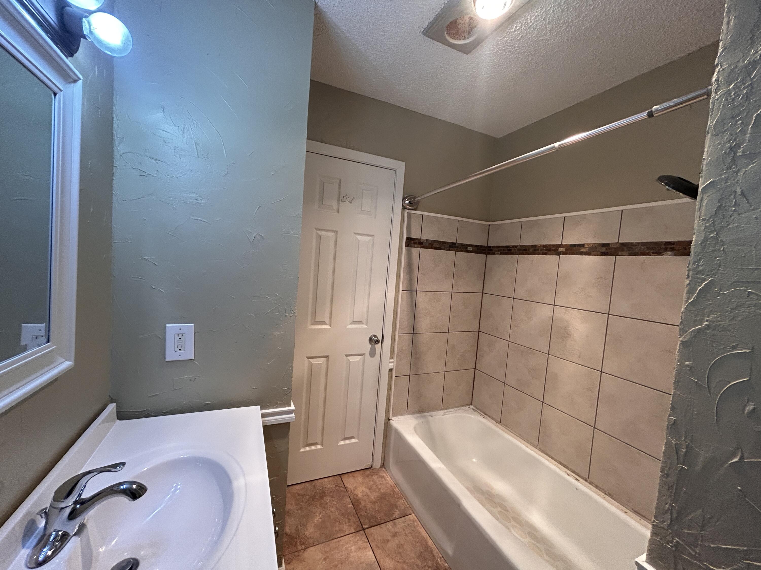 6508 25th Street Lubbock, TX 79407 - Photo 14 of 14 a bathroom with a tub and shower