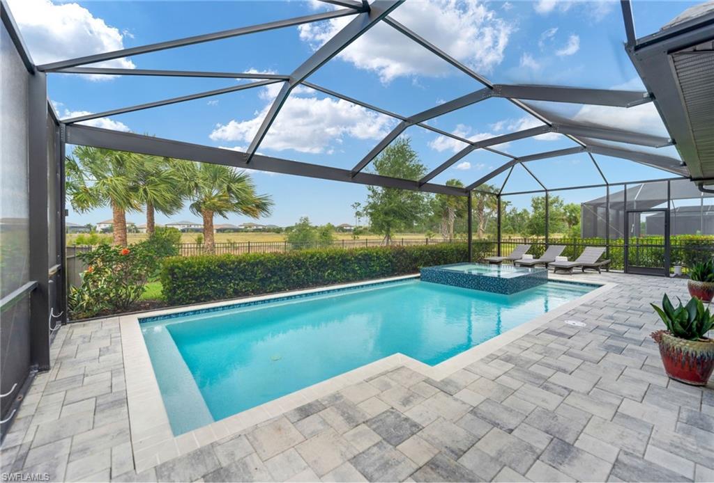 19812 Beechcrest Place Estero, FL 33928 - Photo 18 of 50 a view of a swimming pool with a patio
