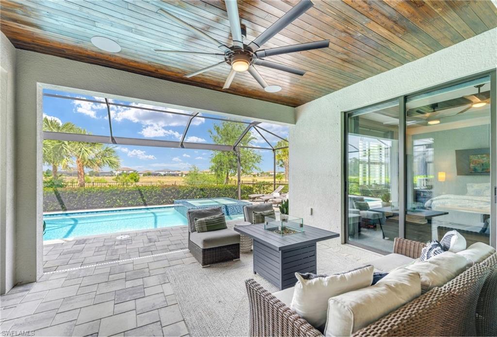 19812 Beechcrest Place Estero, FL 33928 - Photo 2 of 50 a living room with furniture and a floor to ceiling window
