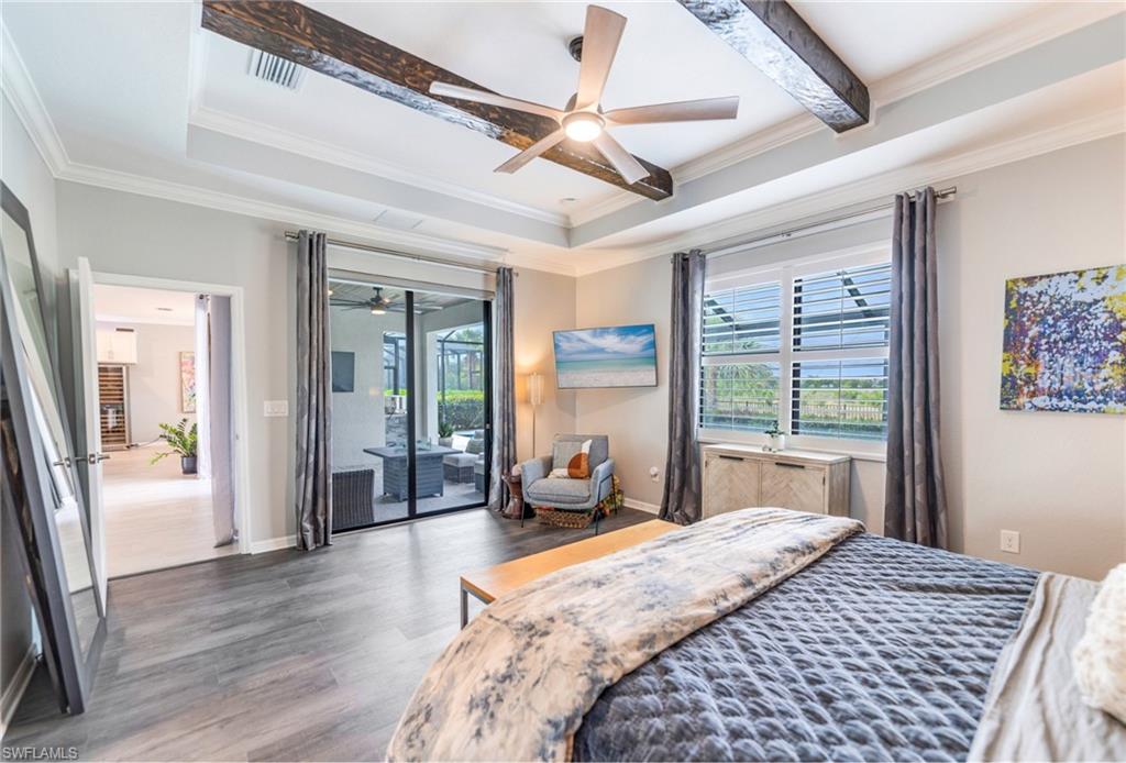 19812 Beechcrest Place Estero, FL 33928 - Photo 23 of 50 a bedroom with a large bed and a large window with wooden floor