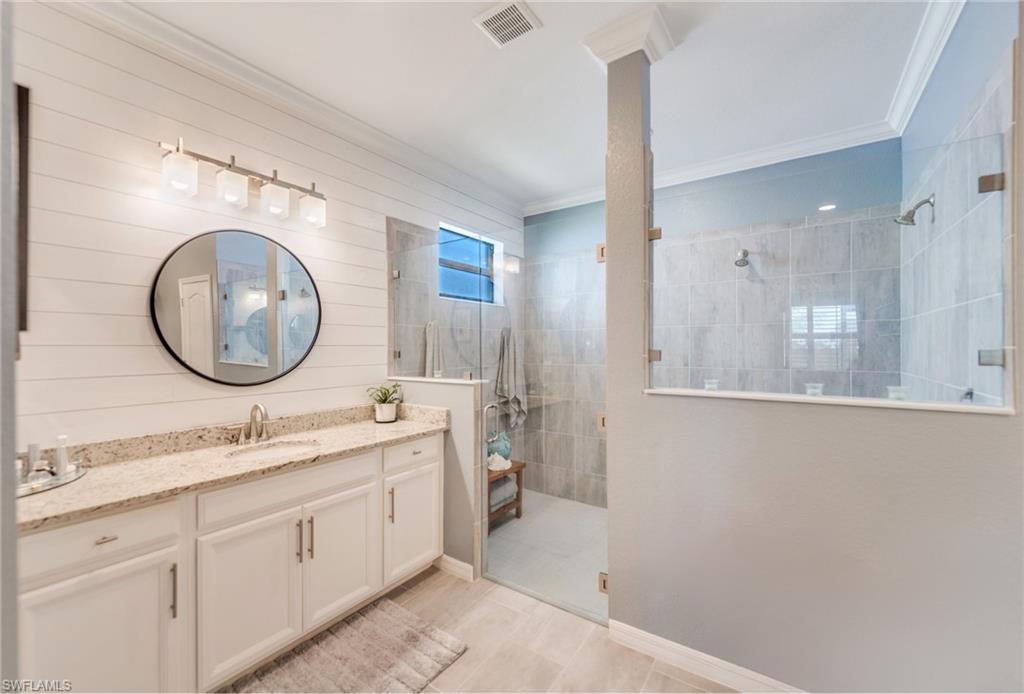 19812 Beechcrest Place Estero, FL 33928 - Photo 24 of 50 a bathroom with a granite countertop sink mirror and vanity