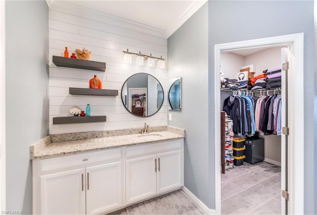 19812 Beechcrest Place Estero, FL 33928 - Photo 25 of 50 a bathroom with a sink and a mirror