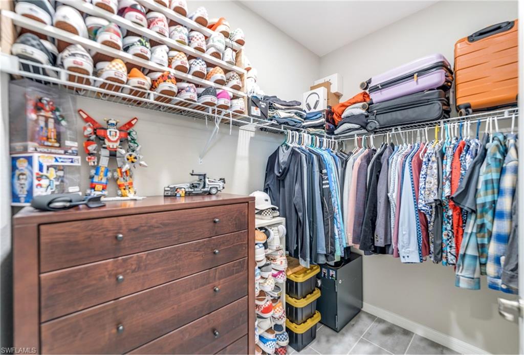 19812 Beechcrest Place Estero, FL 33928 - Photo 26 of 50 a view of walk in closet with clothes and shoes
