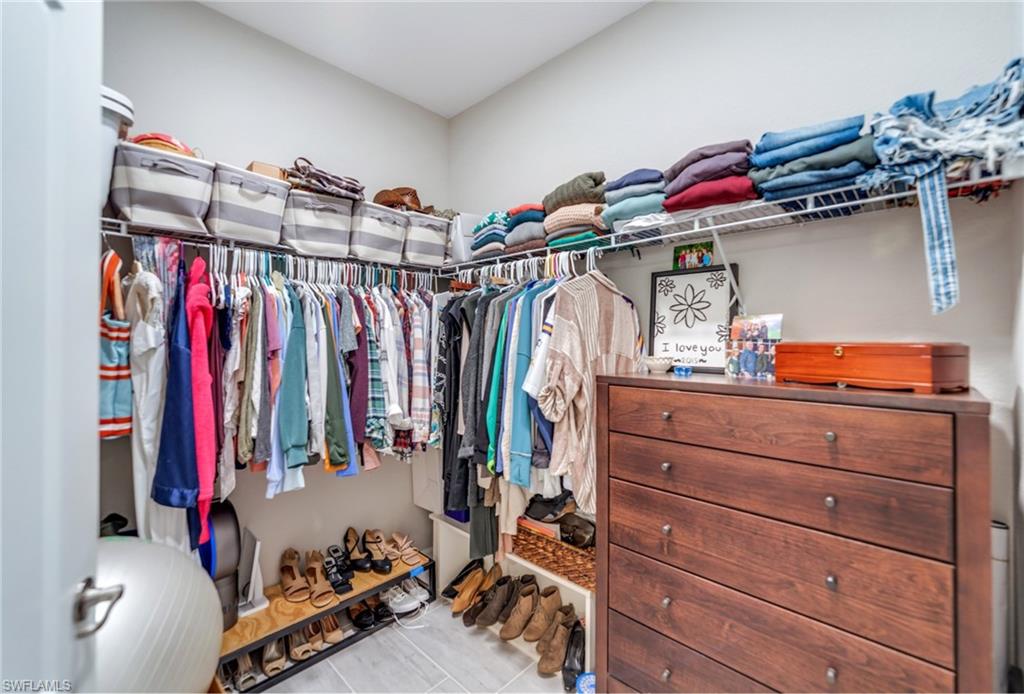 19812 Beechcrest Place Estero, FL 33928 - Photo 27 of 50 a view of walk in closet with clothes