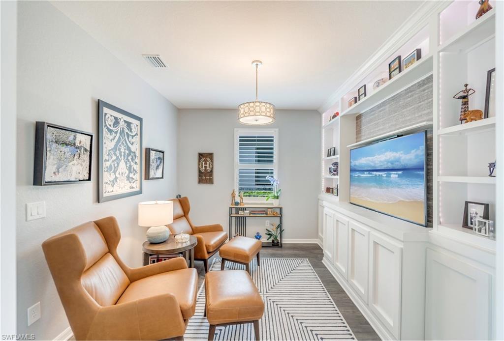 19812 Beechcrest Place Estero, FL 33928 - Photo 29 of 50 a living room with furniture a window and a flat screen tv