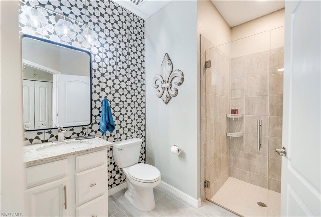 19812 Beechcrest Place Estero, FL 33928 - Photo 35 of 50 a bathroom with a sink a toilet and shower