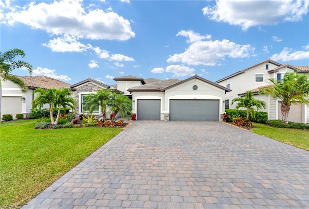 19812 Beechcrest Place Estero, FL 33928 - Photo 5 of 50 a front view of a house with garden