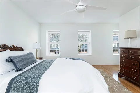 a spacious bedroom with a bed and a dresser