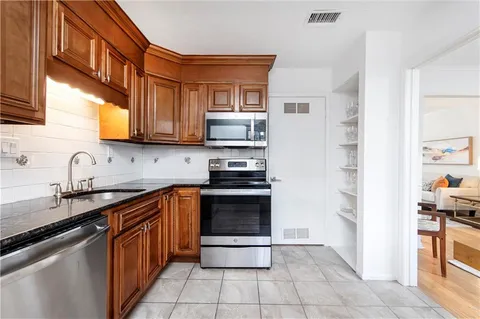 a kitchen with stainless steel appliances and cabinets