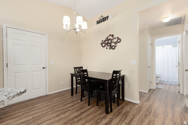 161 West 950 South, Unit S4 St. George, UT 84770 - Photo 8 of 21 Dining space featuring lofted ceiling, wood finished floors, and suspended lighting