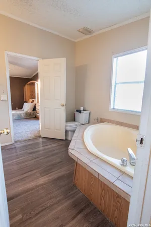 a view of an empty room and wooden floor