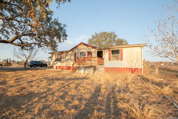 a view of a house with snow on the road