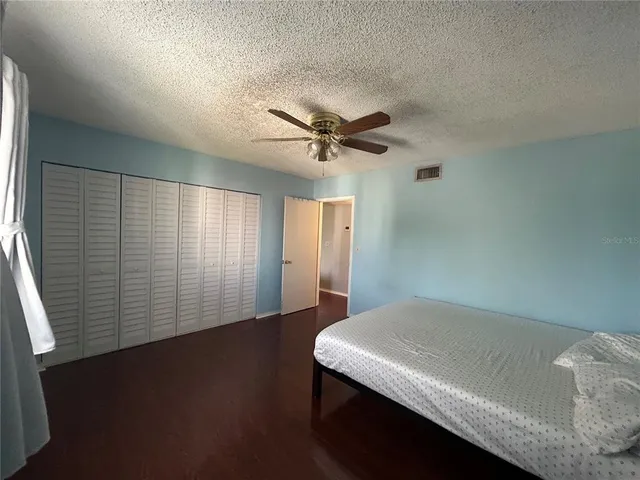a view of a livingroom with a ceiling fan and wooden floor