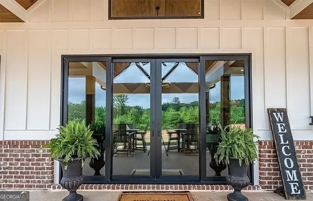 a bathroom with a granite countertop sink and a large mirror