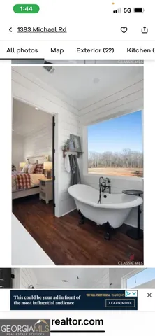 a bedroom with a large bed and a large window