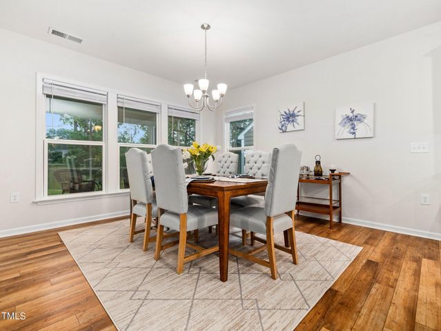 a living room with fireplace furniture and a large window
