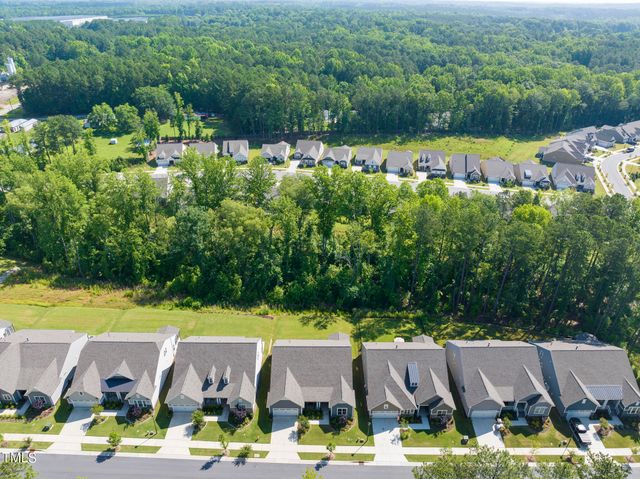 a aerial view of a house with a swimming pool outdoor seating and yard