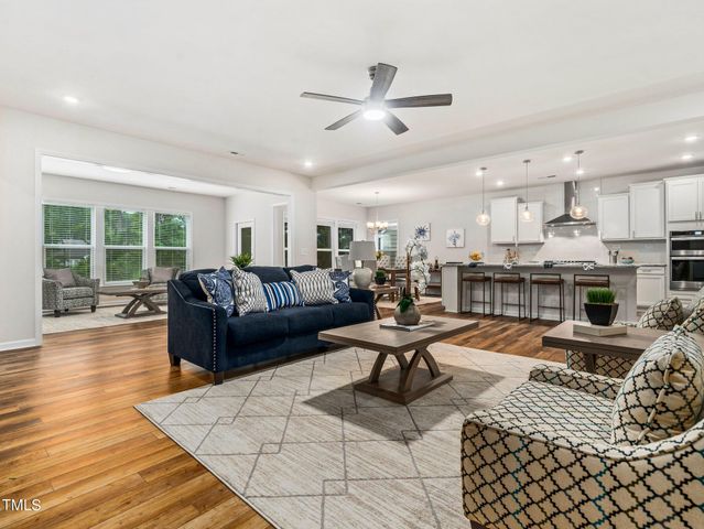 a living room with furniture and kitchen view